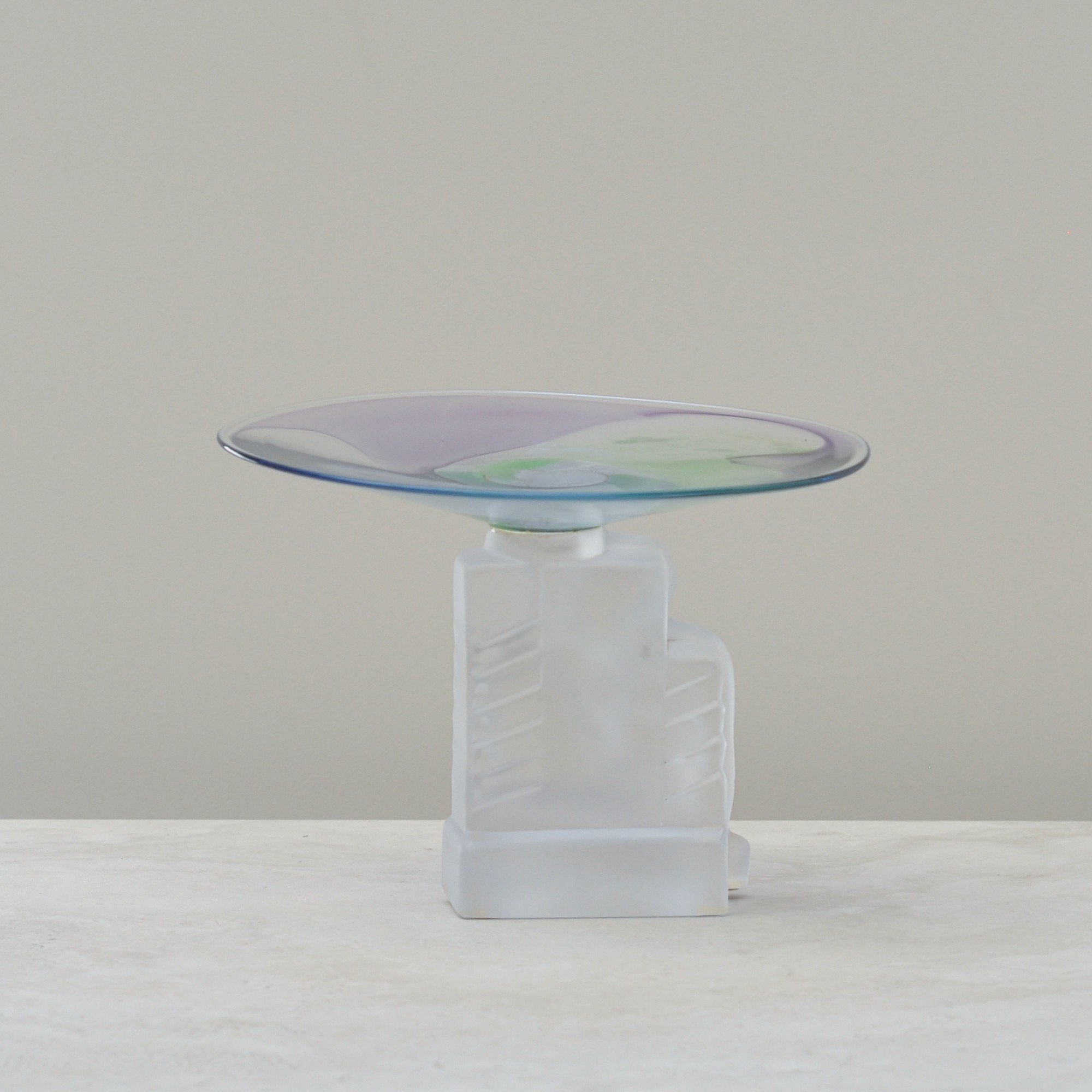 Rear view of the Cristal de Sèvres dish with the frosted seated figure and soft green and purple glass top.