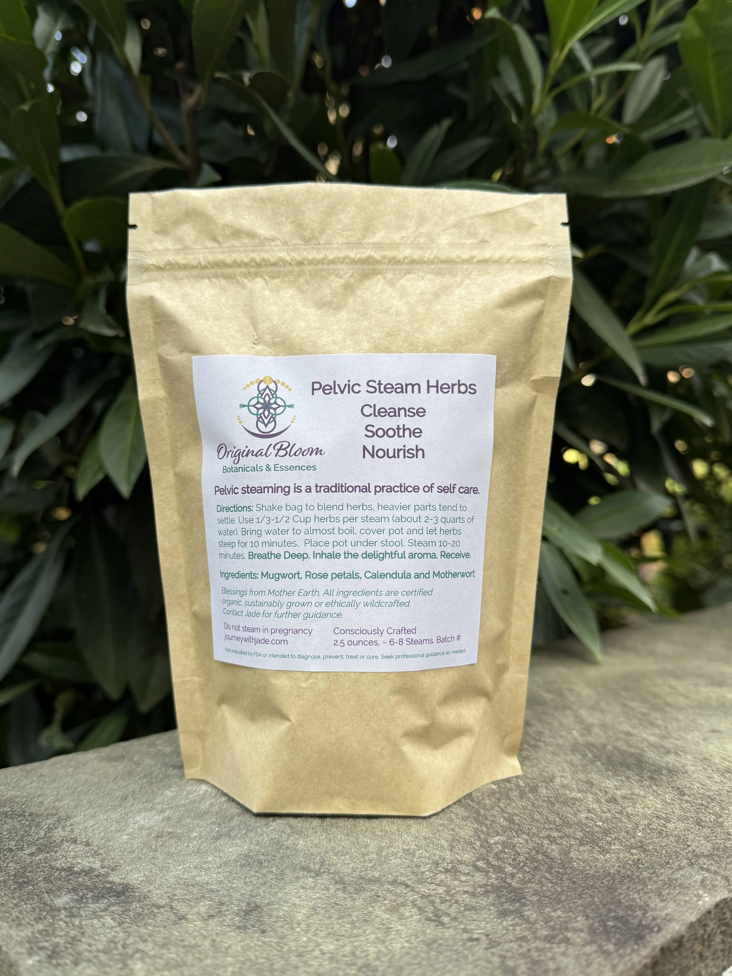 A brown paper bag labeled 'Pelvic Steam Herbs' sitting outdoors in front of green foliage, with instructions for a self-care herbal steam practice.