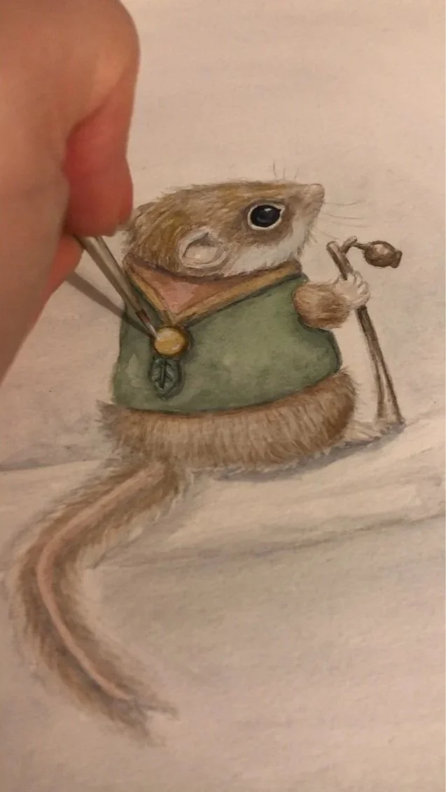 Painting a feathertail glider with a staff with a gumnut on it