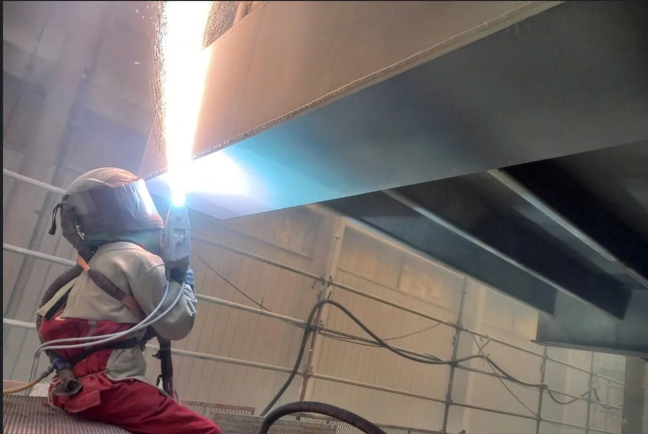 Completed zinc thermal spray coating on wind turbine flanges for robust corrosion protection.