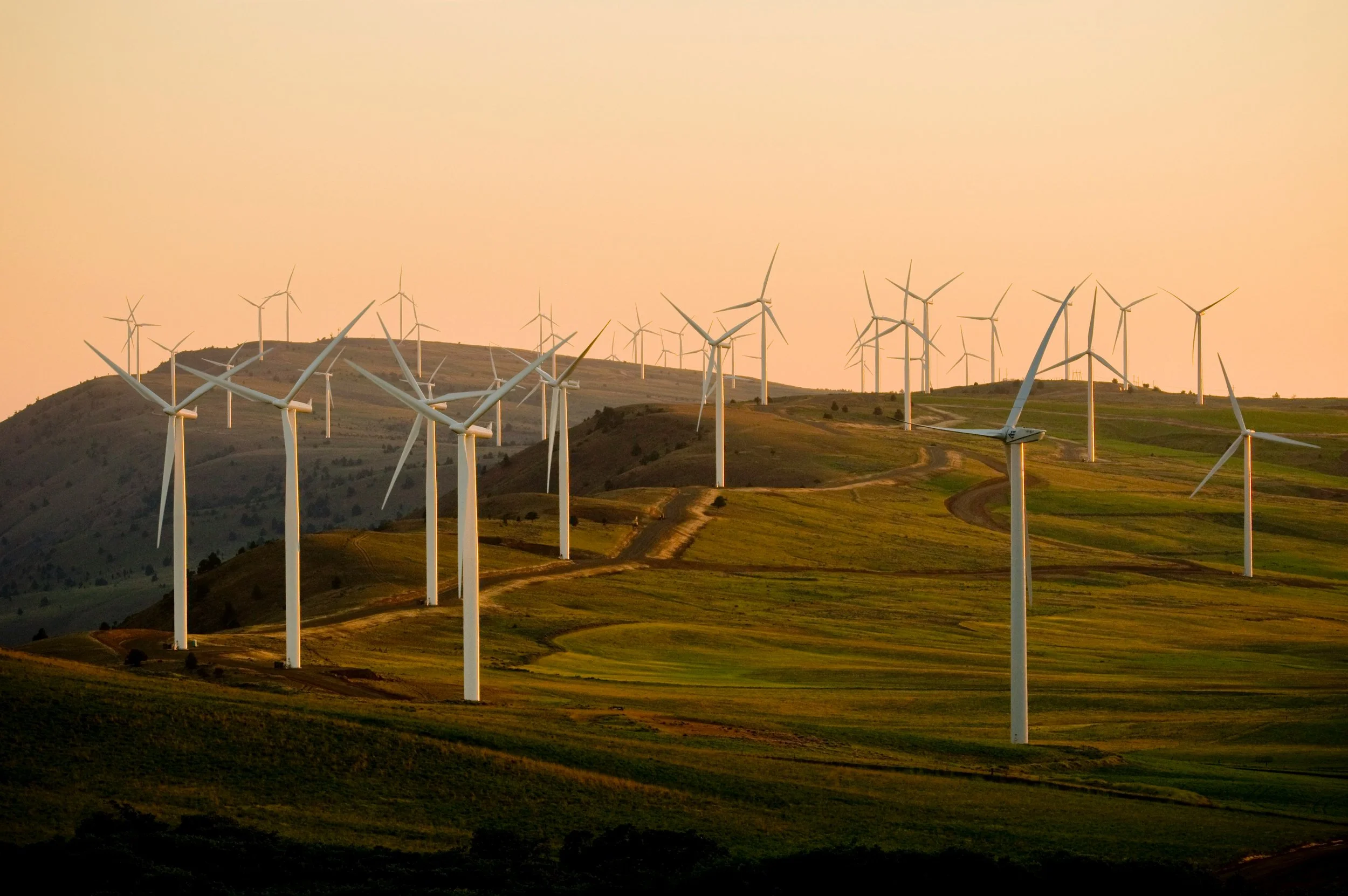 Line drawing of a wind turbine with three blades and a tall tower.