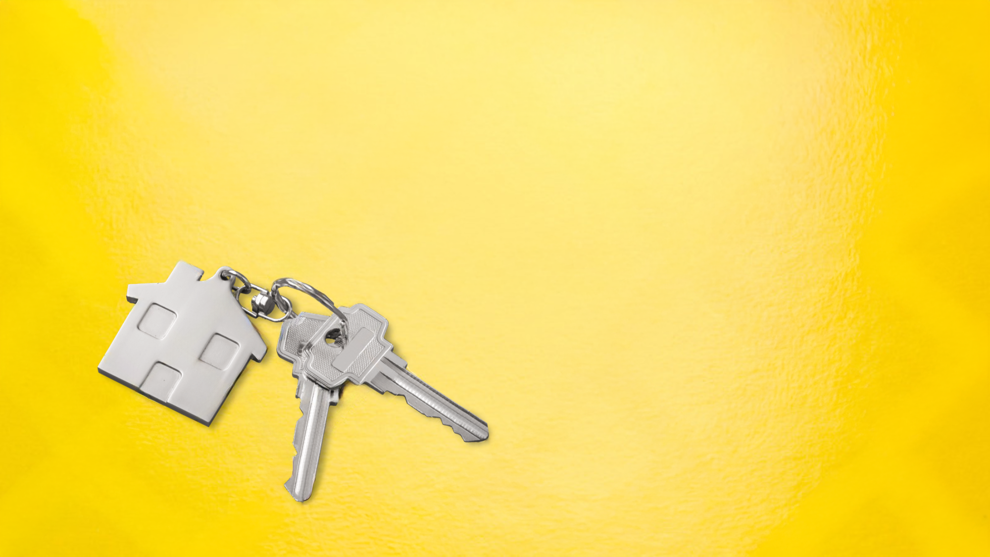 Keys attached to a keychain with a house-shaped keychain on a yellow background.