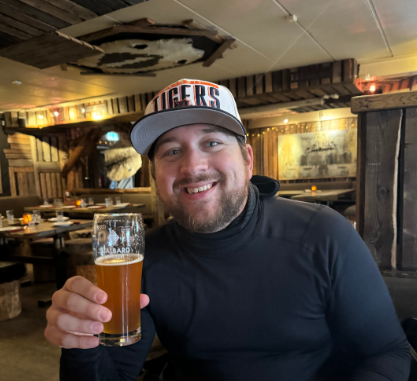 man-drinking-beer-smiling-cozy-eatery.jpg