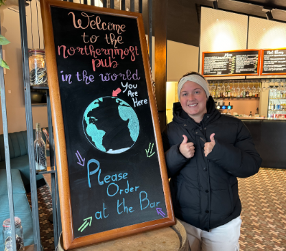 woman-smiling-thumbs-up-northernmost-pub-sign.jpg