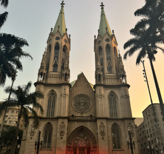 Catedral de Sé in São Paulo, Brazil, illuminated at night with its historic Gothic architecture visible.