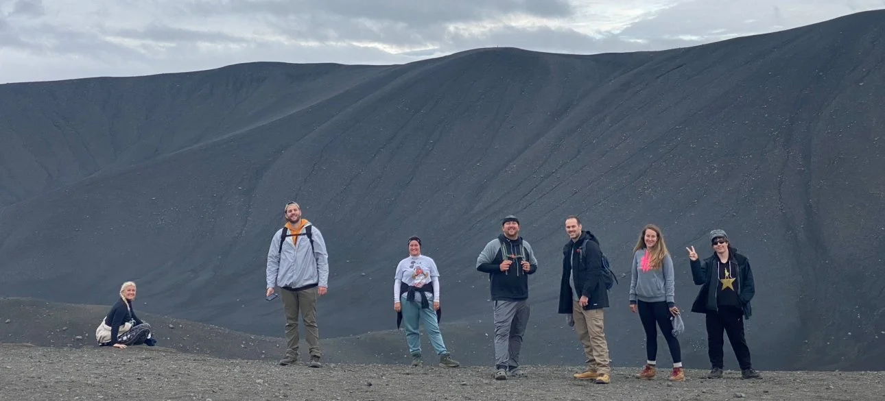 Group of young people standing on the edge of Hverfjall Crater in Iceland.