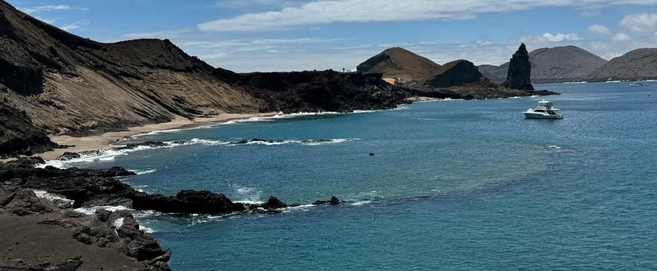 Aerial view of Bartolomé Island in the Galápagos Islands, showing its volcanic landscape and surrounding ocean.