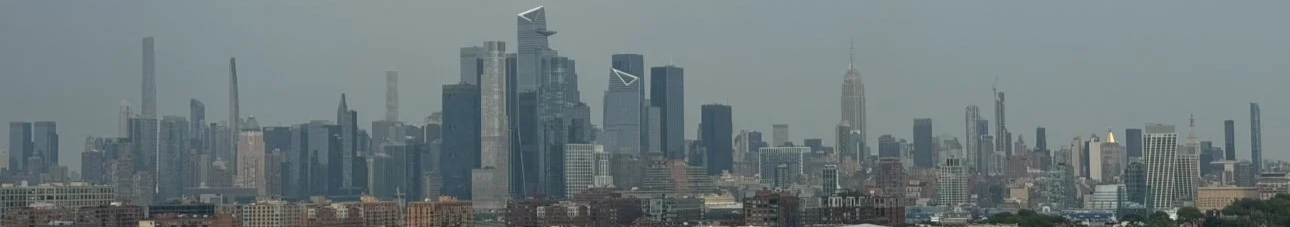 The New York City skyline during the day under a clear sky.