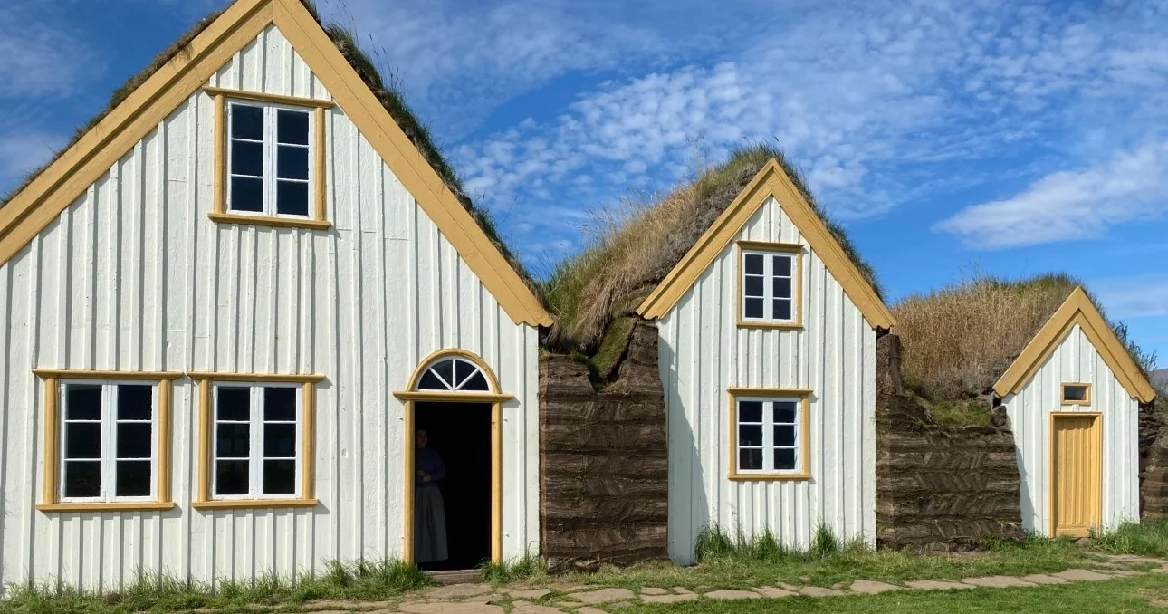 Traditional Glaumbær turf houses in Iceland with grass-covered roofs and wooden structures.