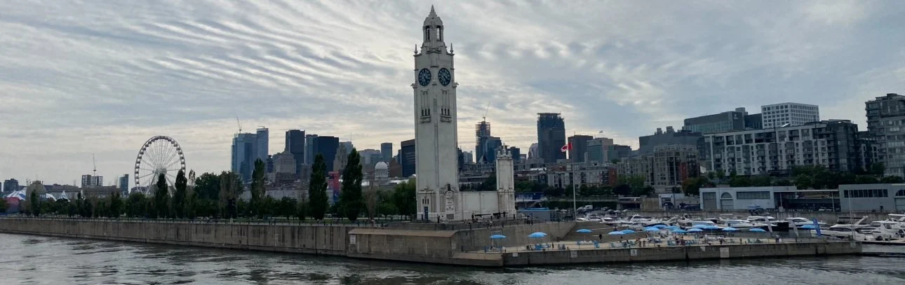 Vieux Port of Montreal with the Clock Tower Beach skyline, featuring the historic tower, waterfront, and city buildings.