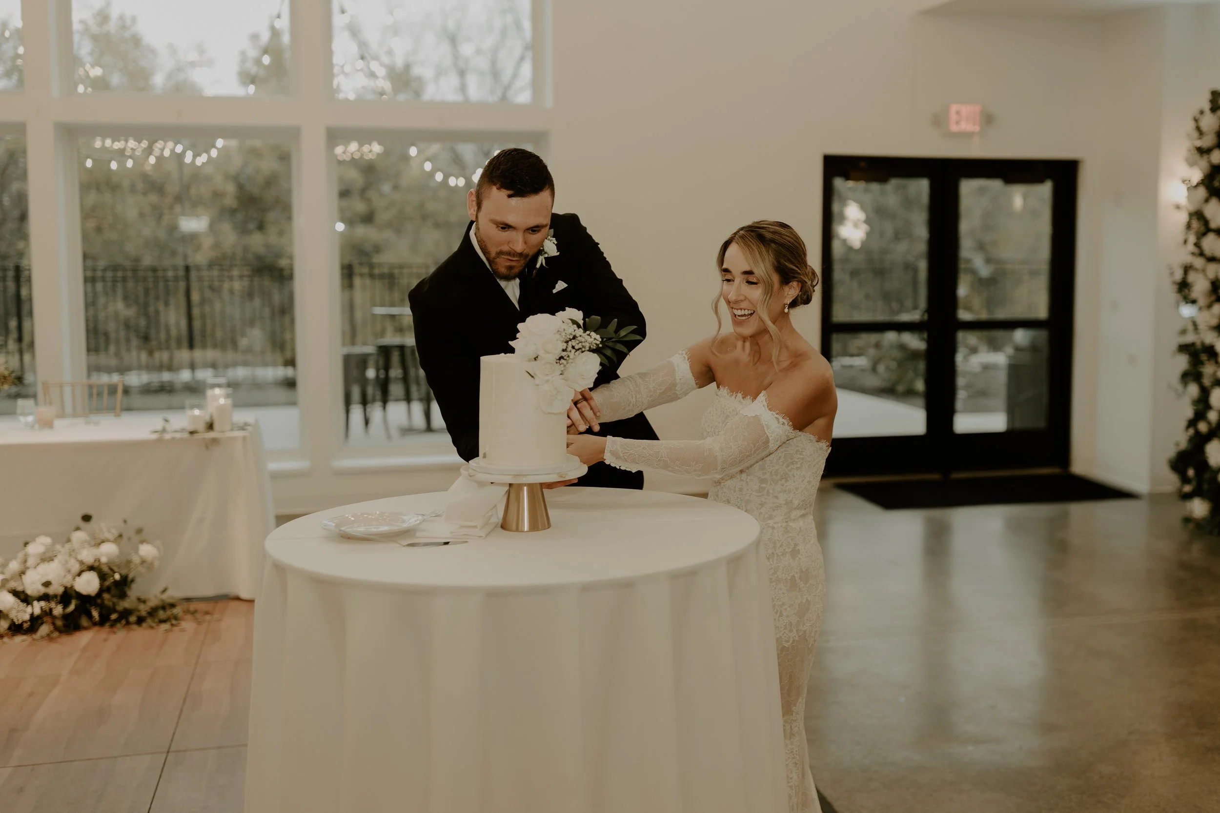 Bride and groom cutting a wedding cake at reception.