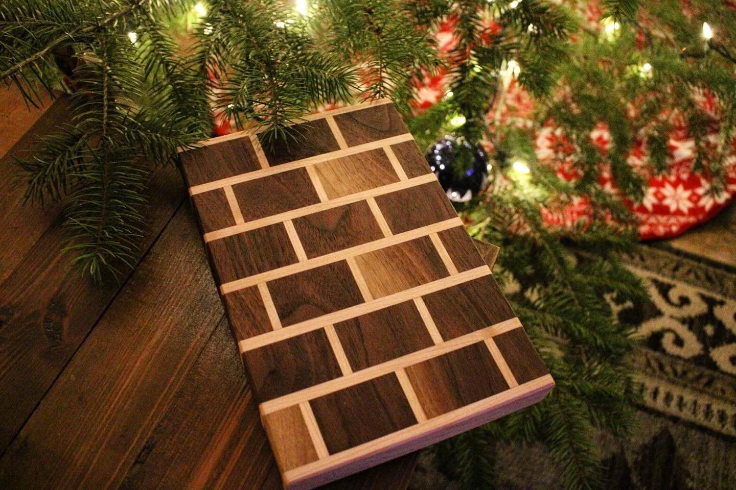 This small walnut and maple brick-pattern edge grain cutting board is the perfect addition to any kitchen. Ideal for pairing, charcuterie, or everyday prep, this is the one of a kind board and ready to use. Finished for durability and food-safe use, 