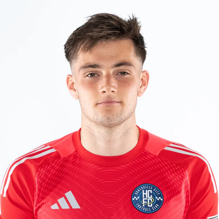 Young man in a red sports jersey with HC Ede badge