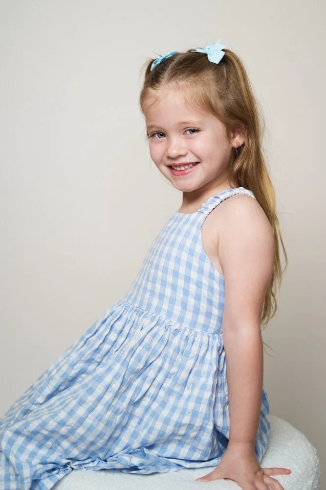Light-filled childcare portrait in Sydney capturing a genuine smile and playful expression.