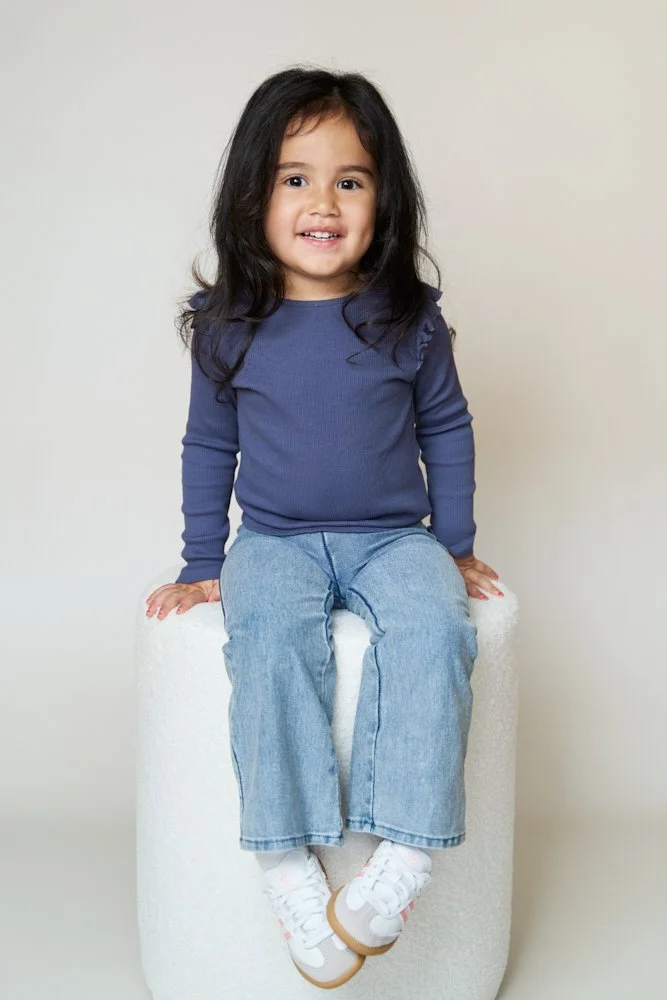Light-filled childcare portrait in Sydney capturing a genuine smile and playful expression.