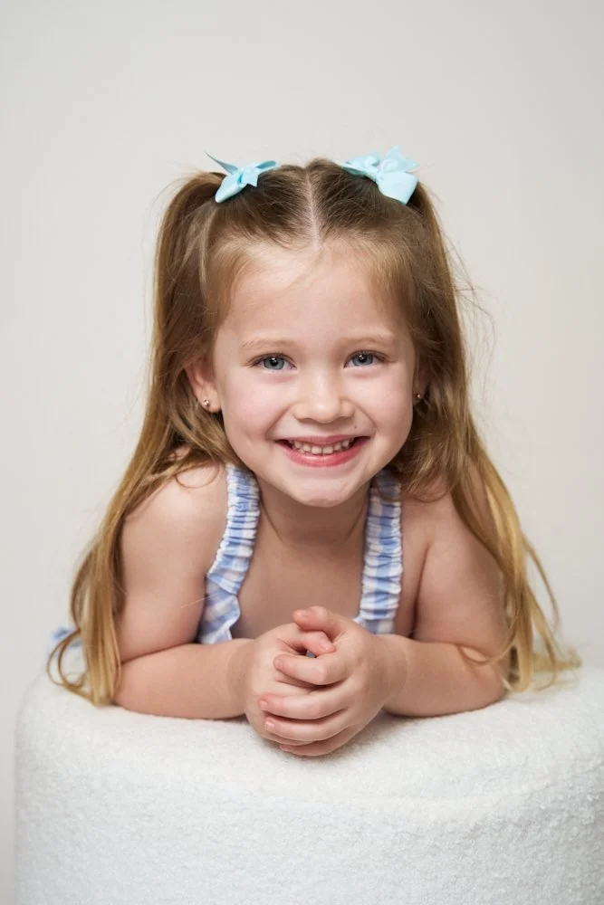 Light-filled childcare portrait in Sydney capturing a genuine smile and playful expression.