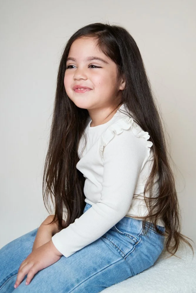 Light-filled childcare portrait in Sydney capturing a genuine smile and playful expression.