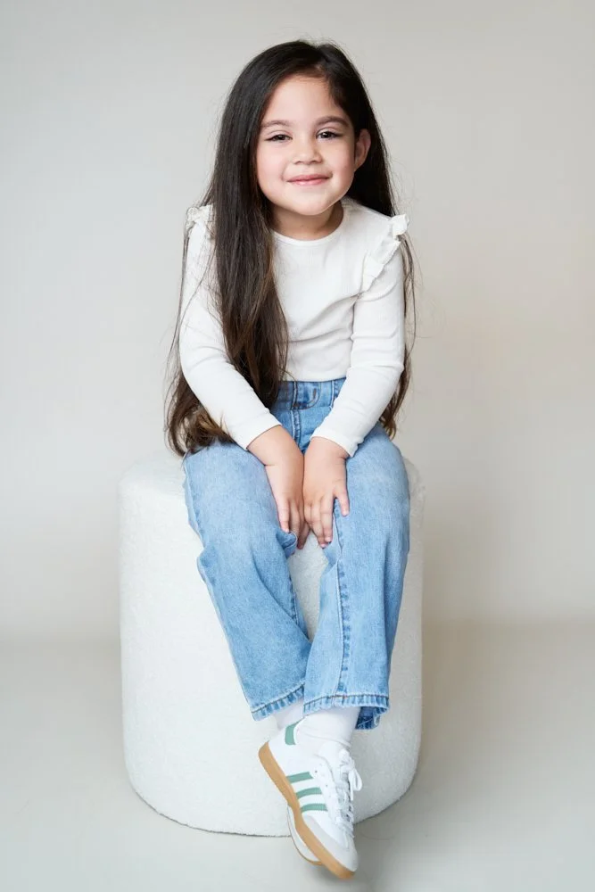 Light-filled childcare portrait in Sydney capturing a genuine smile and playful expression.