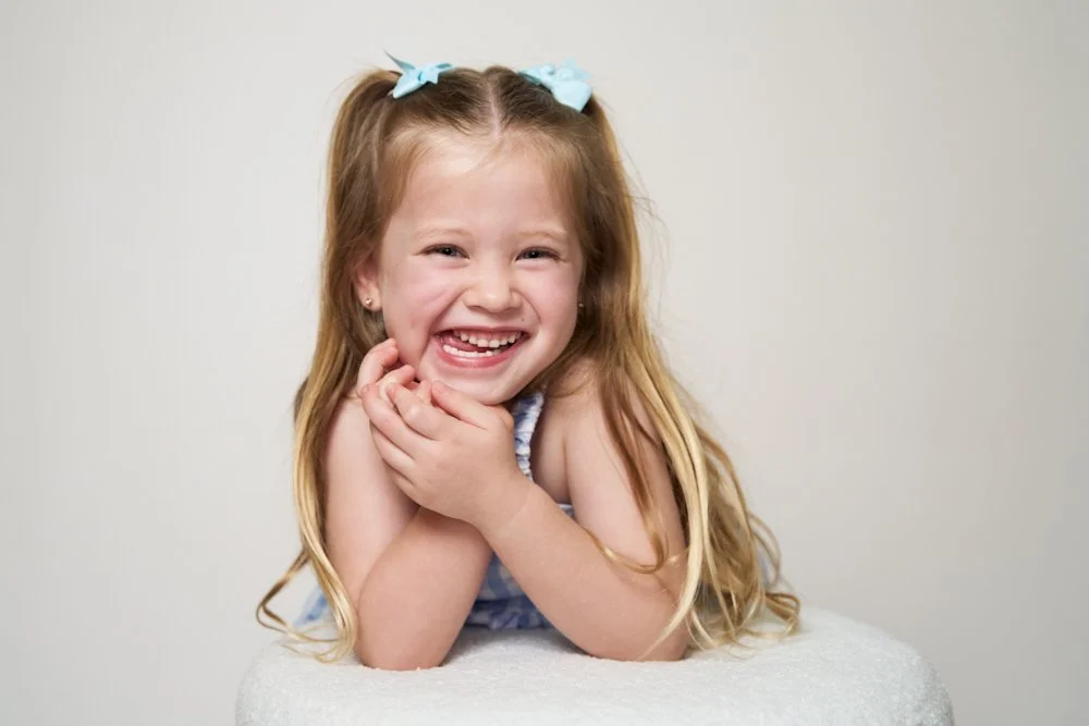Light-filled childcare portrait in Sydney capturing a genuine smile and playful expression.