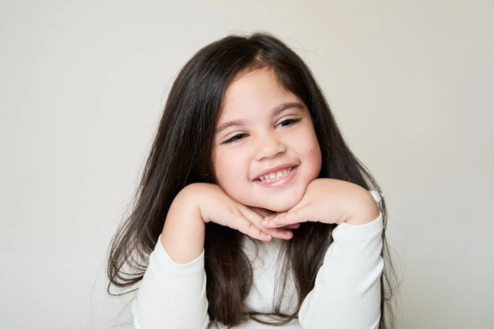 Light-filled childcare portrait in Sydney capturing a genuine smile and playful expression.