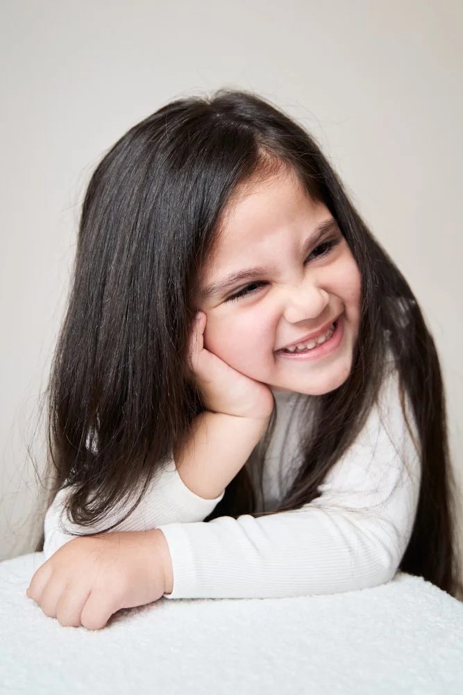 Light-filled childcare portrait in Sydney capturing a genuine smile and playful expression.