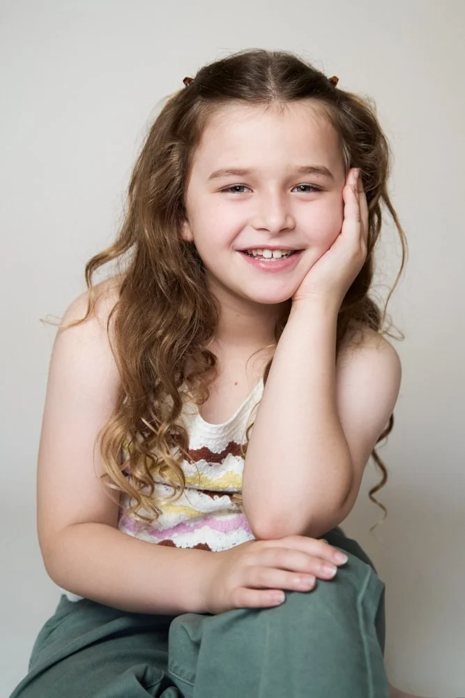 Light-filled childcare portrait in Sydney capturing a genuine smile and playful expression.