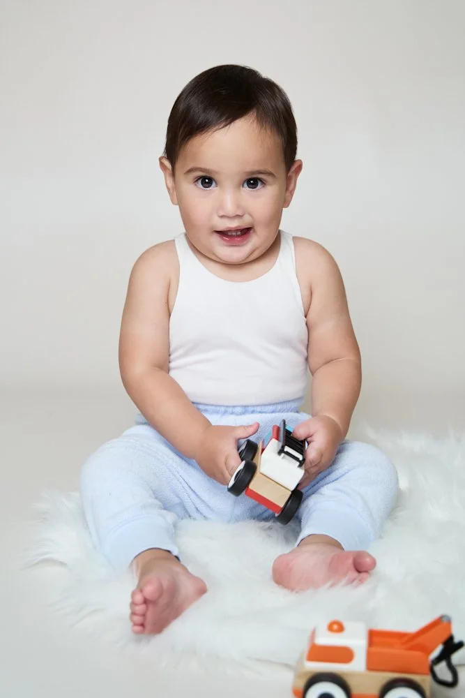 Light-filled childcare portrait in Sydney capturing a genuine smile and playful expression.