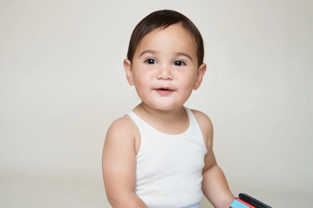 Light-filled childcare portrait in Sydney capturing a genuine smile and playful expression.