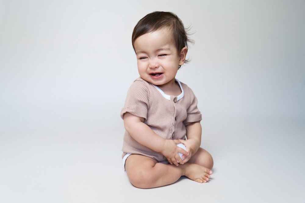 Light-filled childcare portrait in Sydney capturing a genuine smile and playful expression.