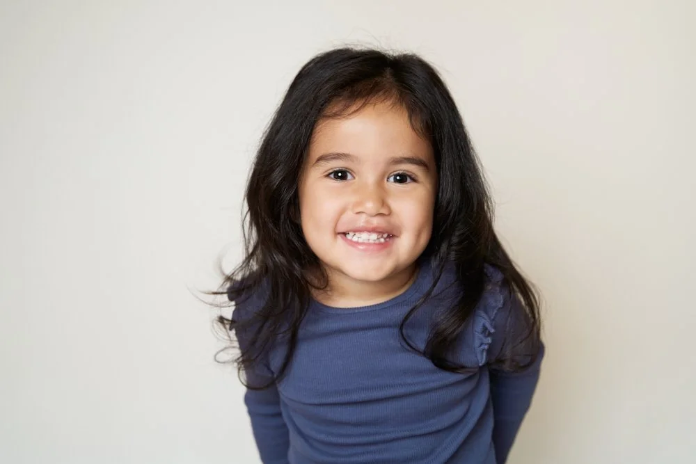 Light-filled childcare portrait in Sydney capturing a genuine smile and playful expression.