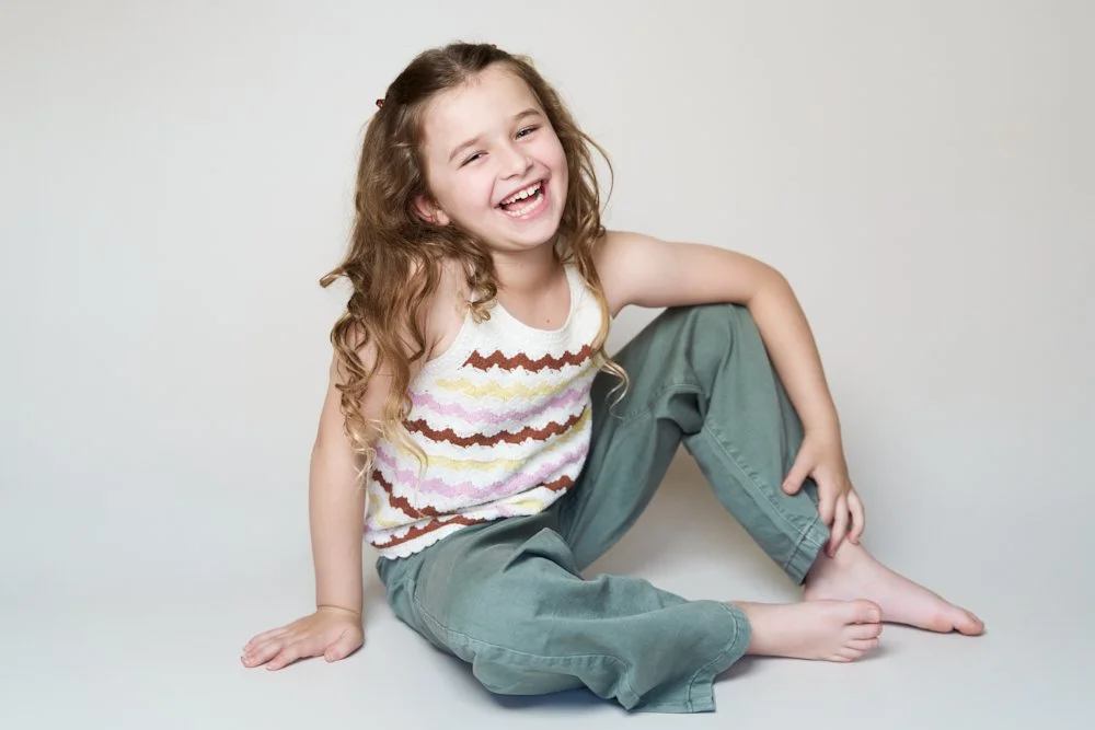 Light-filled childcare portrait in Sydney capturing a genuine smile and playful expression.