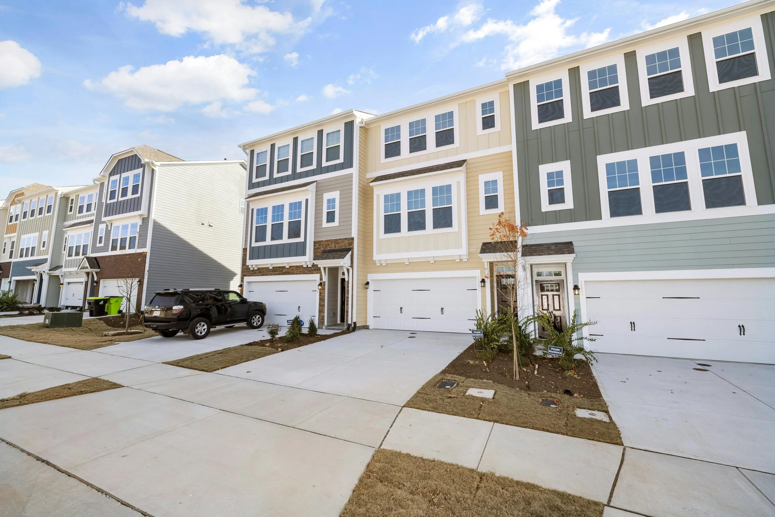 a row of modern townhomes on a sunny day