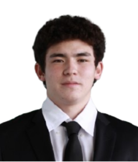 Portrait of a young man with curly dark hair in a black suit, white shirt, and black tie against a plain white background.