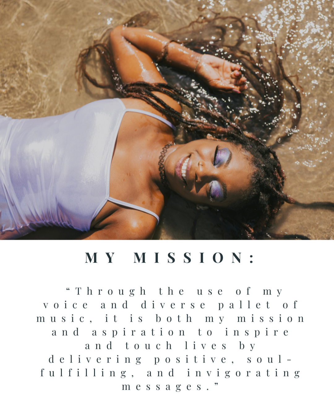 A woman with long braided hair lies on her back in shallow water, smiling with eyes closed, wearing colorful makeup, a black choker, and a white sleeveless top.