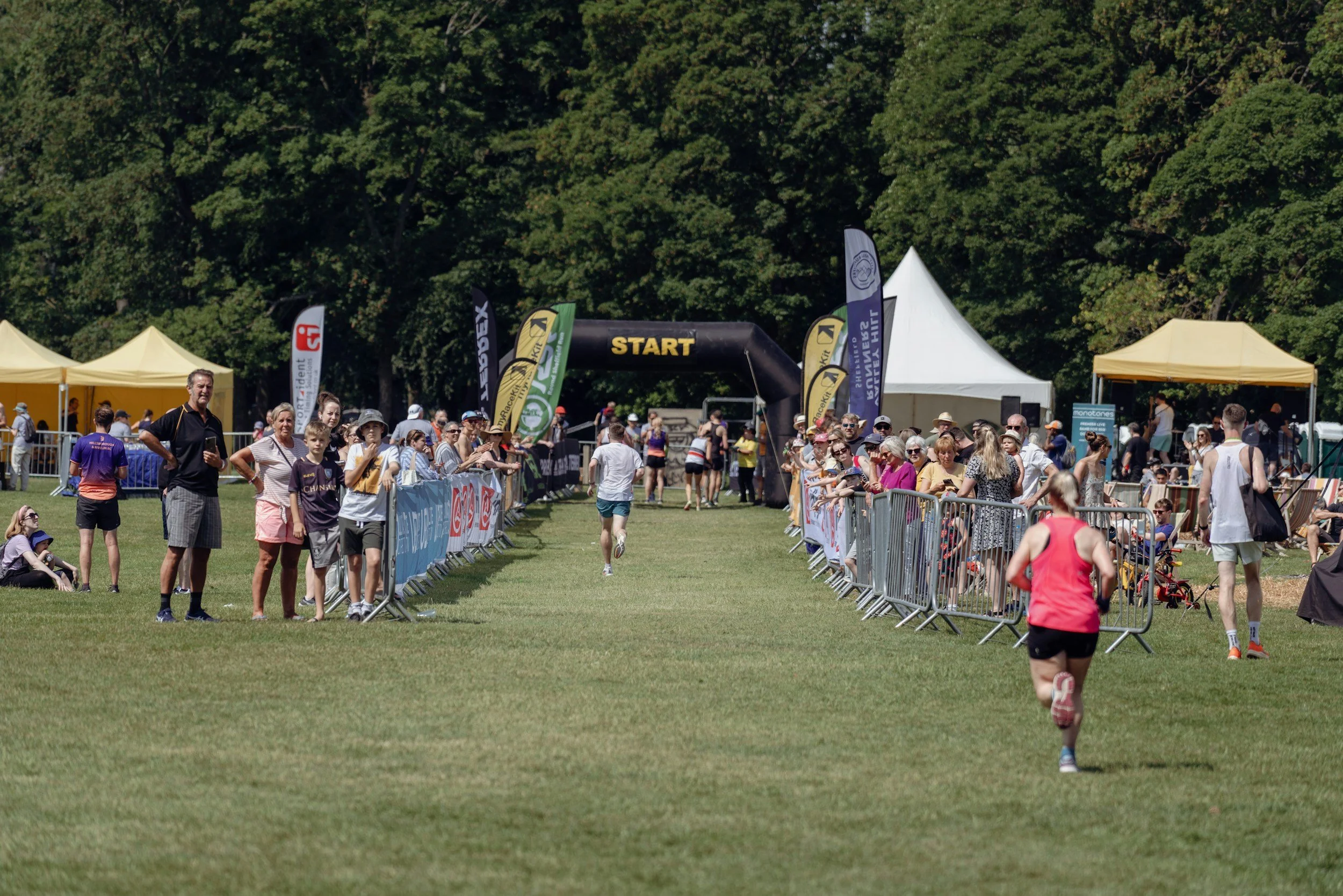race finish line with arch and trees