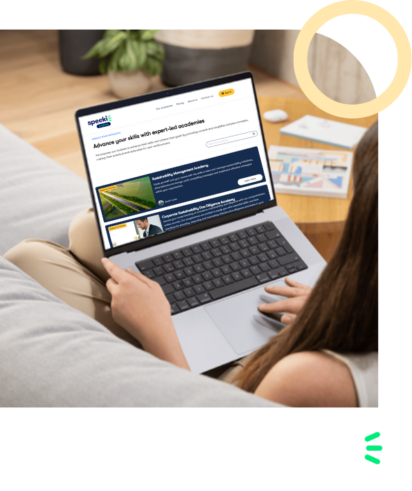 Person sitting on a couch using a laptop to browse an online education platform.