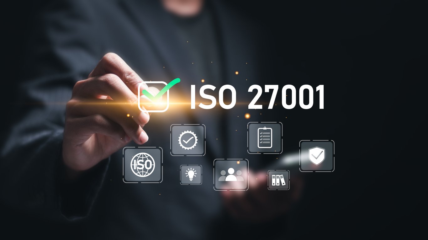 A person touching a virtual screen displaying the text 'ISO 27001' and icons representing security, global standards, and documentation.