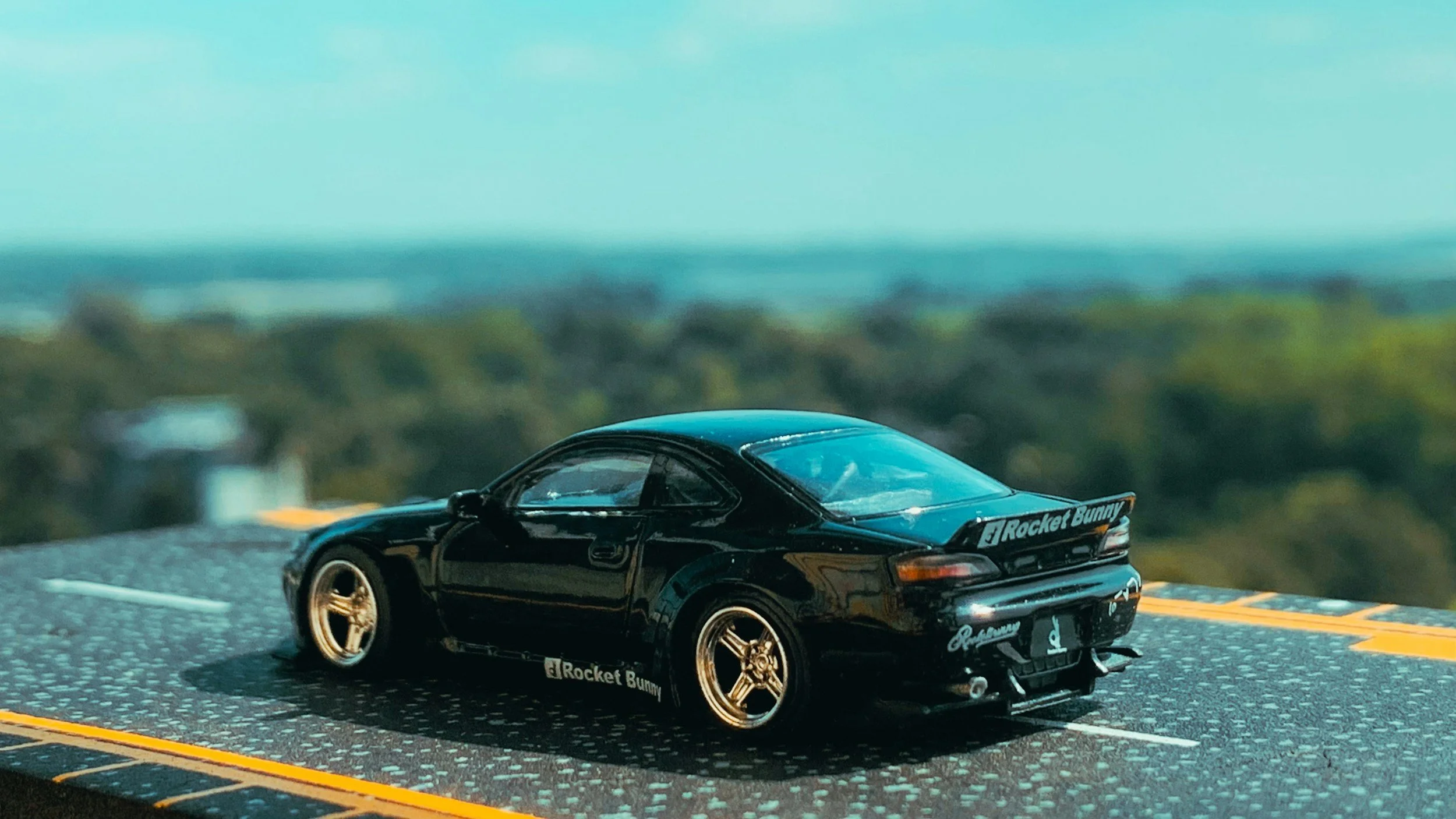 MINIATURE TOY CAR ON A SMALL SCALE STREET