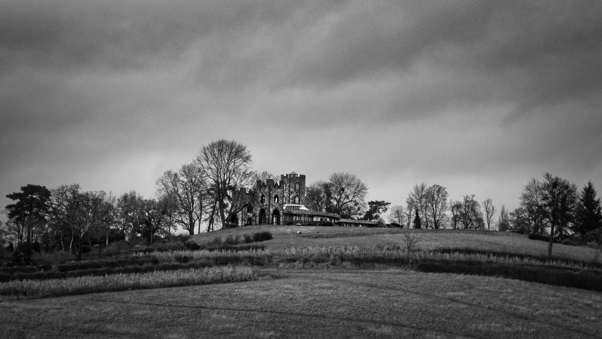 Black and white photography of Lord Boston's Folly, Hedsor Park, Chiltern Hills Buckinghamshire. This Grade II listed flint sham castle features four castellated towers and was captured on a 2008 Sony A350 CCD sensor for a filmic, high-contrast look.