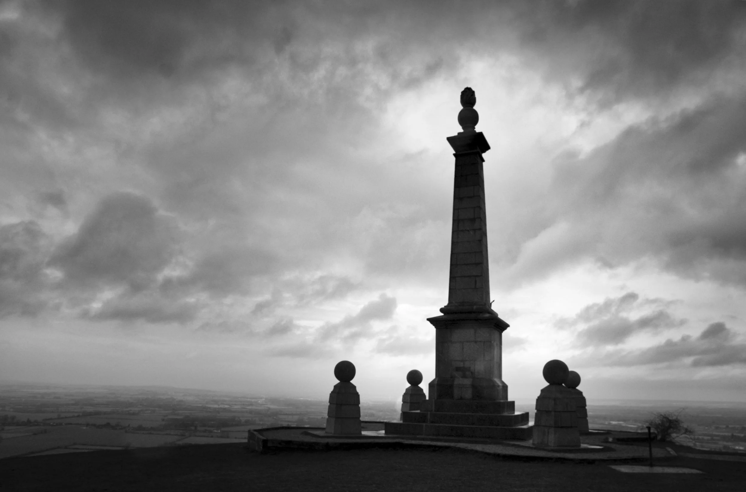 Coombe Hill Memorial silhouetted against a dramatic winter sky, Chiltern Hills, Buckinghamshire — black and white landscape photography
