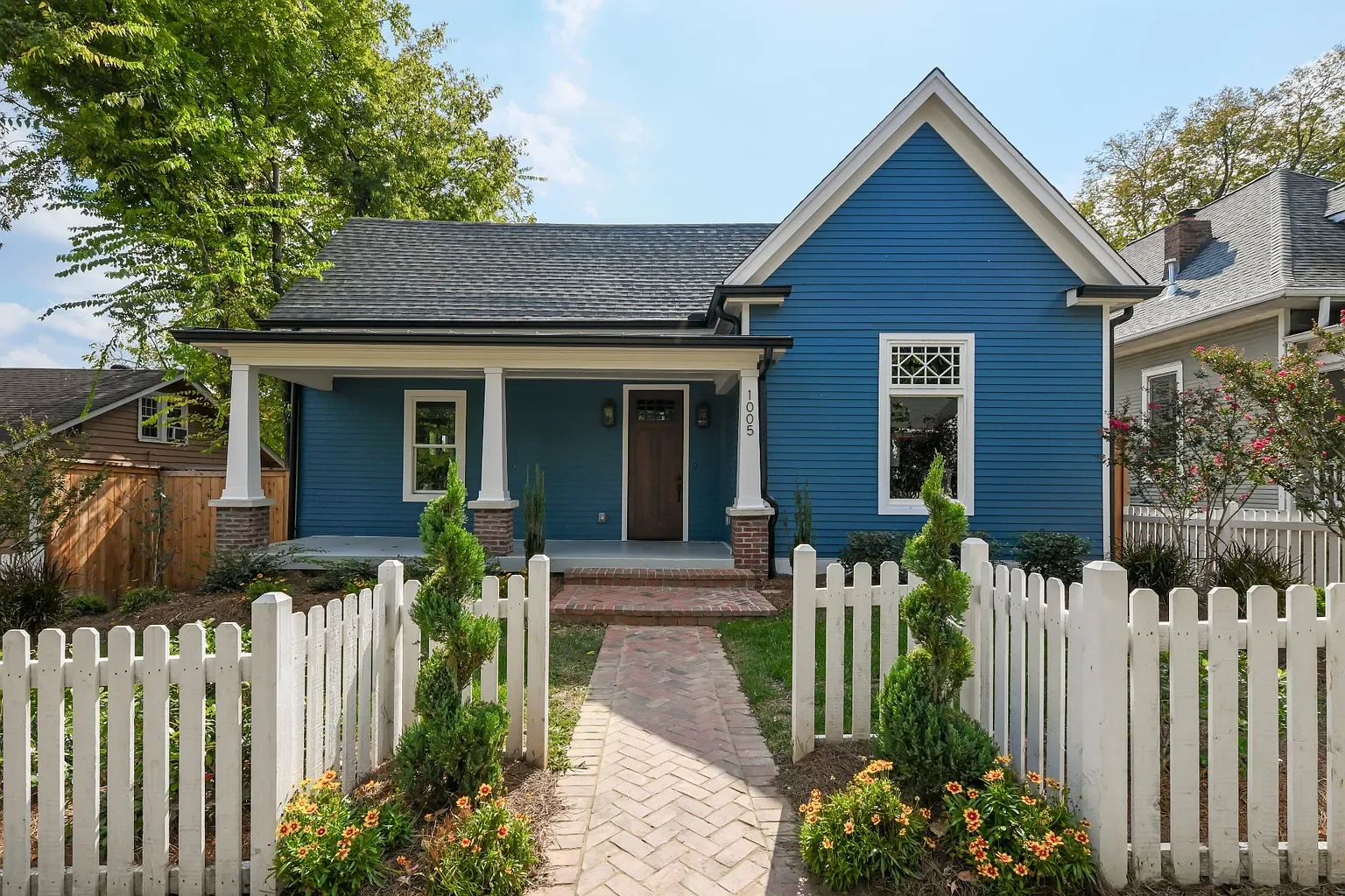 Scenic view of a lake with green hills in the foreground and mountains with cloud cover in the background.