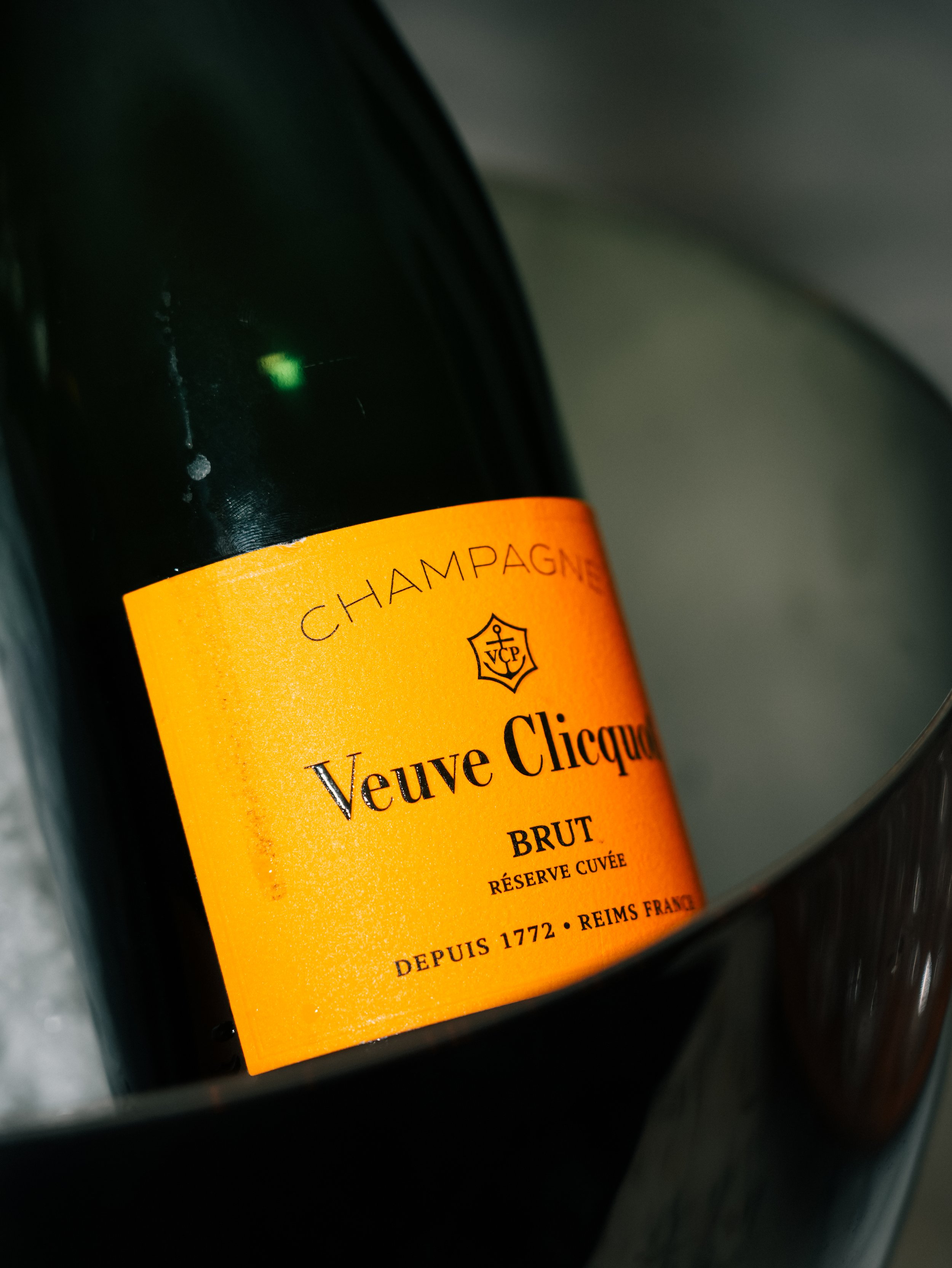 Bottle of Veuve Clicquot champagne inside an ice bucket.