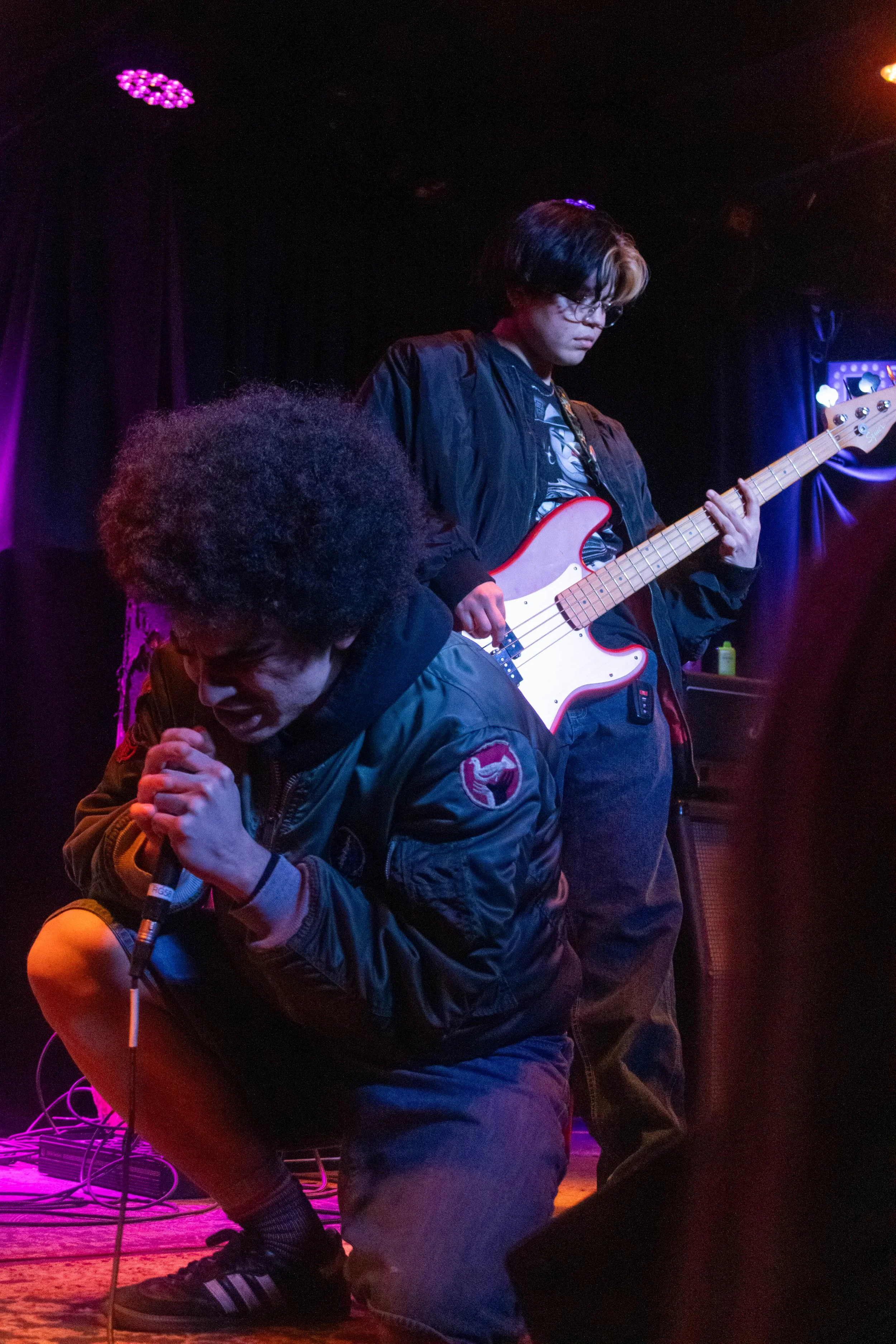 Houston belts into the mic as Demello plays a baseline.