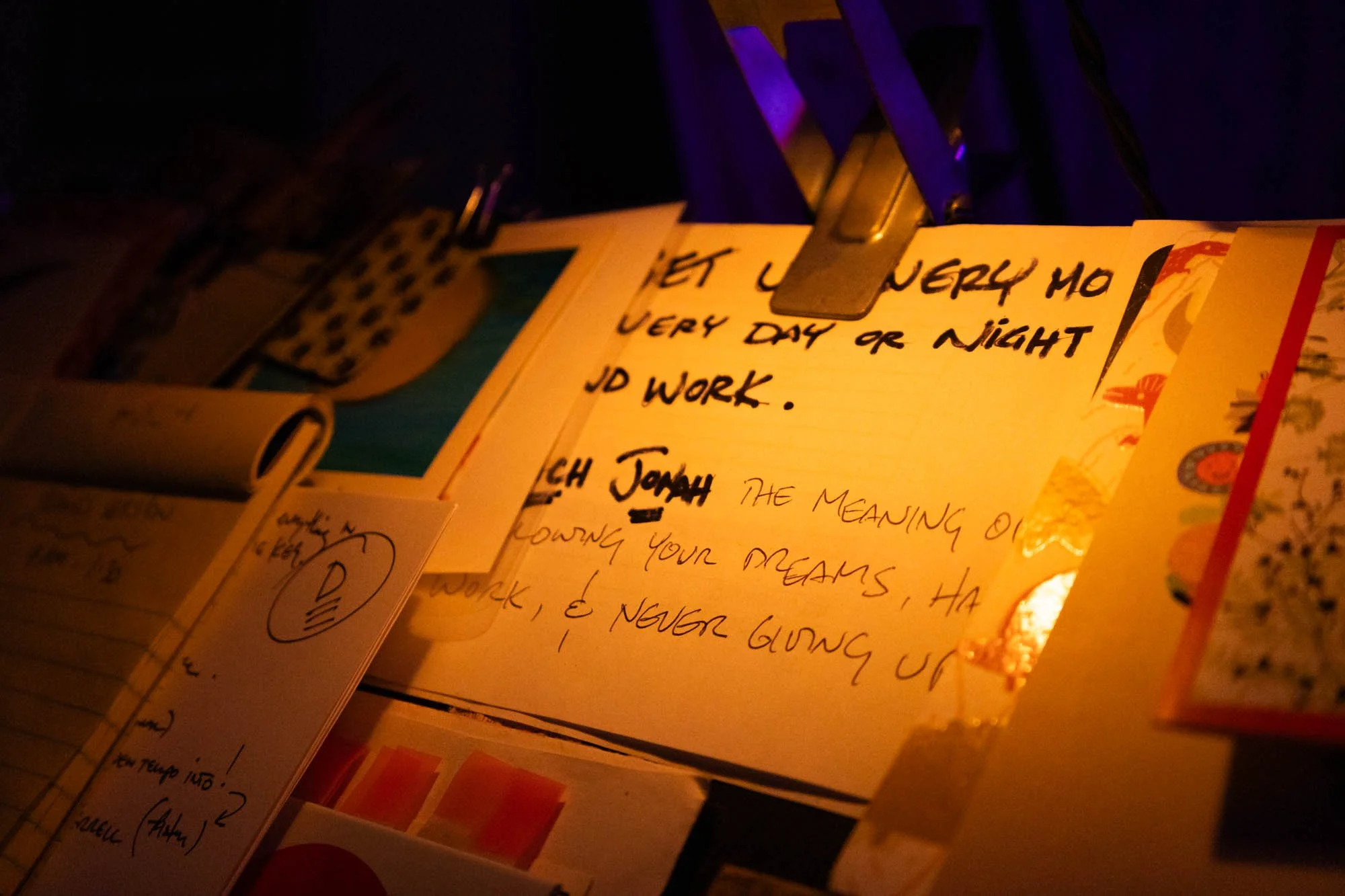 A note is pinned on David Pierce's music stand in his studio. The note reads his son's name, Jonah, and a motivational message.
