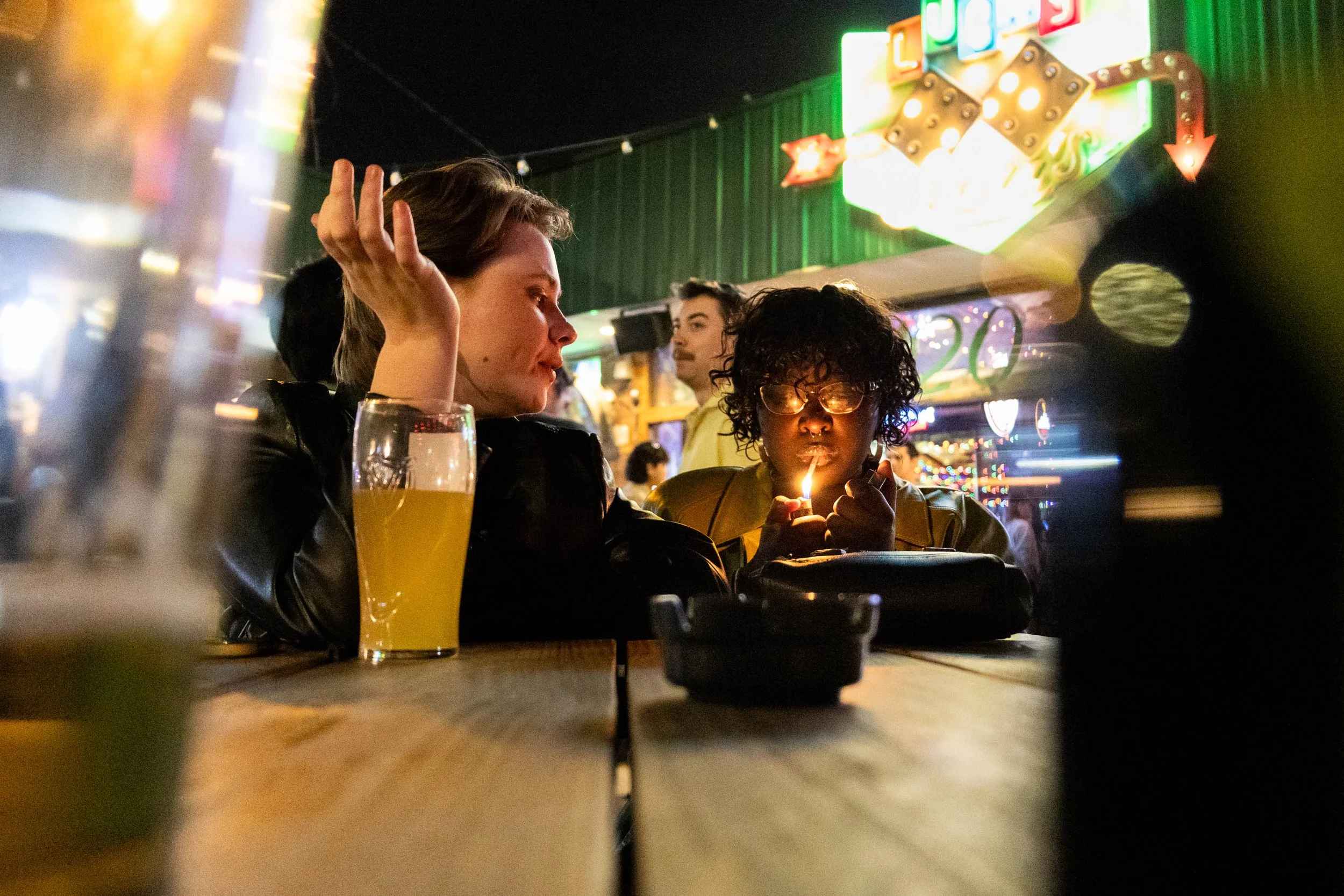 During Lucky Lou's weekly Pint Night, UNT English and Philosophy major Cricket Wier tells a story to their partner, UNT Drawing and Painting major Khadeeja Lamin. The two are regulars at Lou's for pint night with their friend group. (Published in the