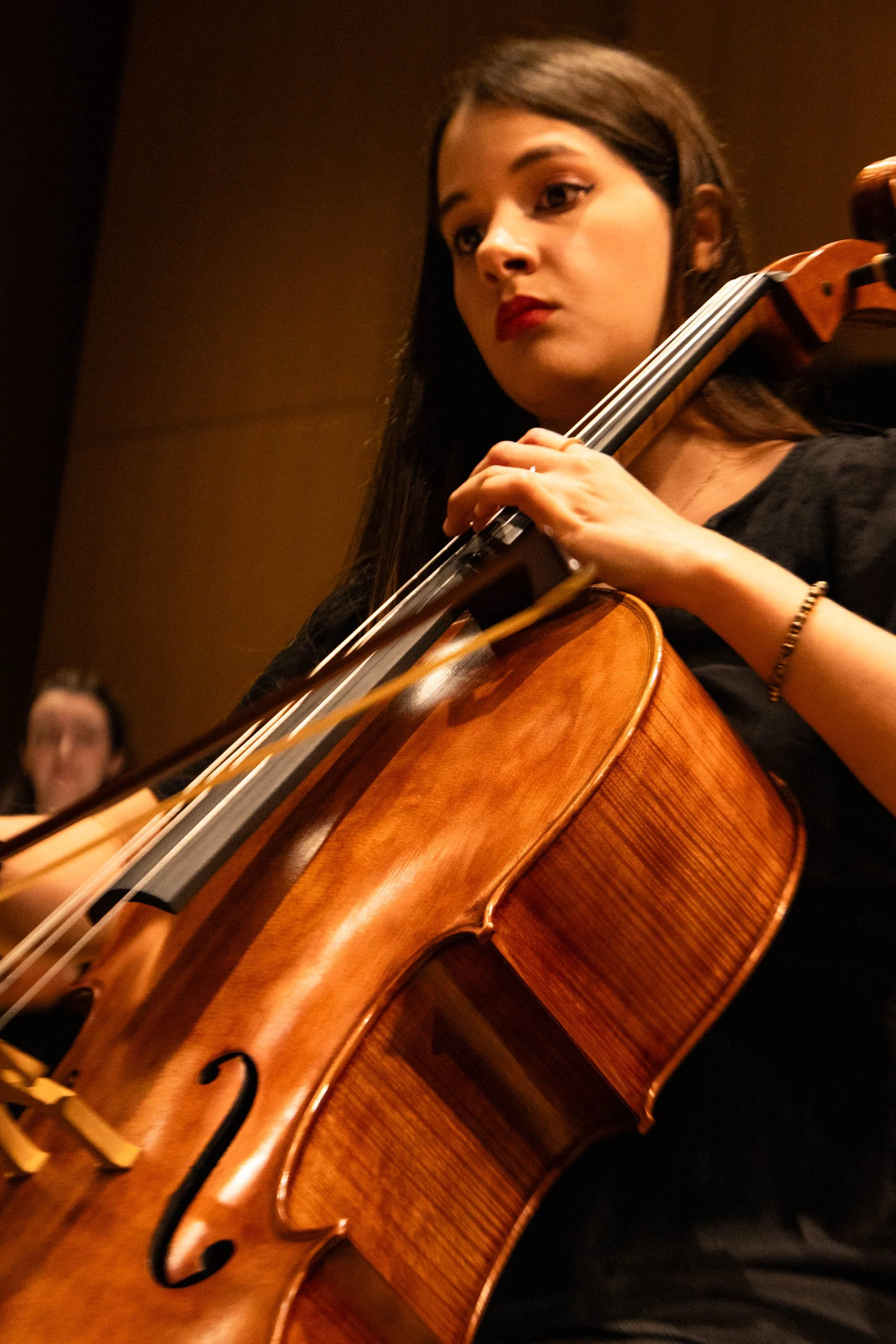 UNT student and cellist Angelica Rodriguez Lanza reads the Variations on A Dream sheet music as she plays. The first movement in this concerto was written by Music Composition junior Demetrius Robinson Jr, meant to represent the idea of perfection.