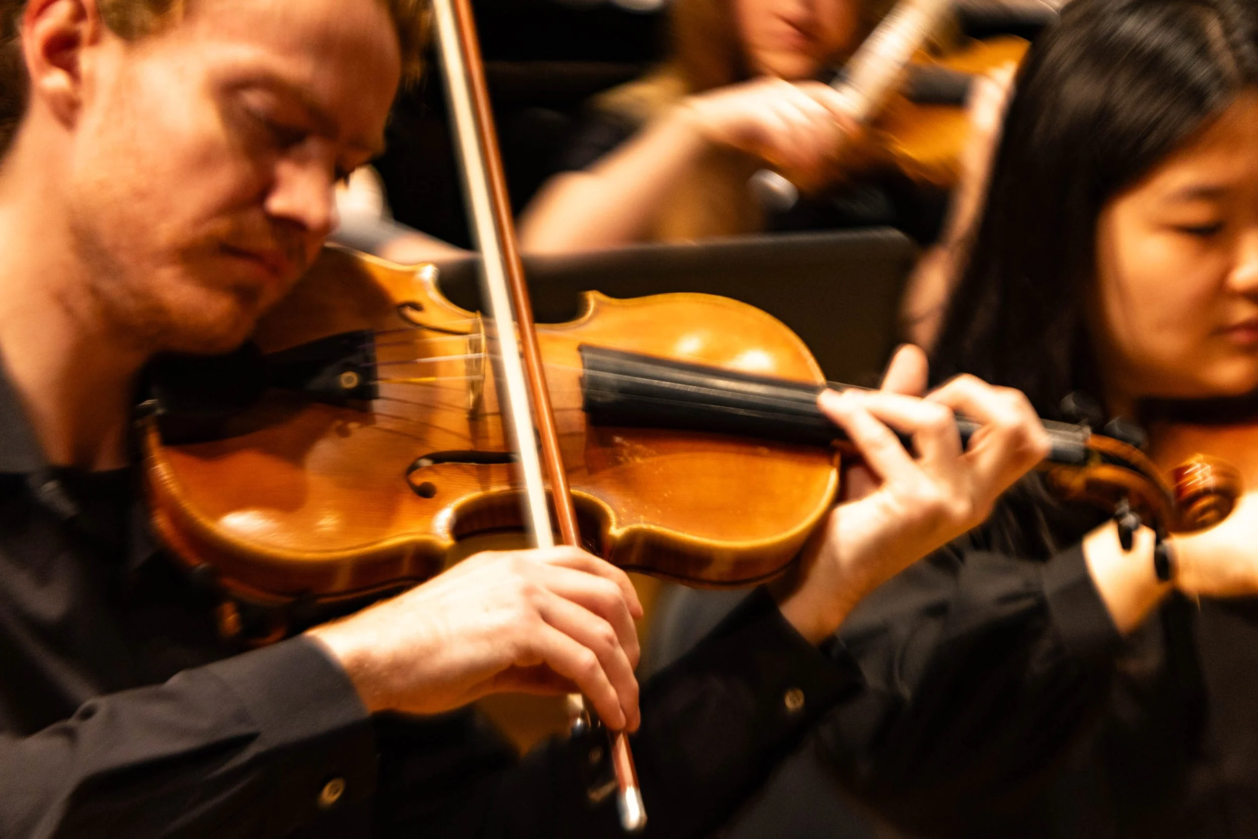 Violinist Joseph Redding focuses on his bow as he plays Movement 3 from Variations on A Dream. This movement was written by Jilin Zhang, representing hopes and dreams for success.