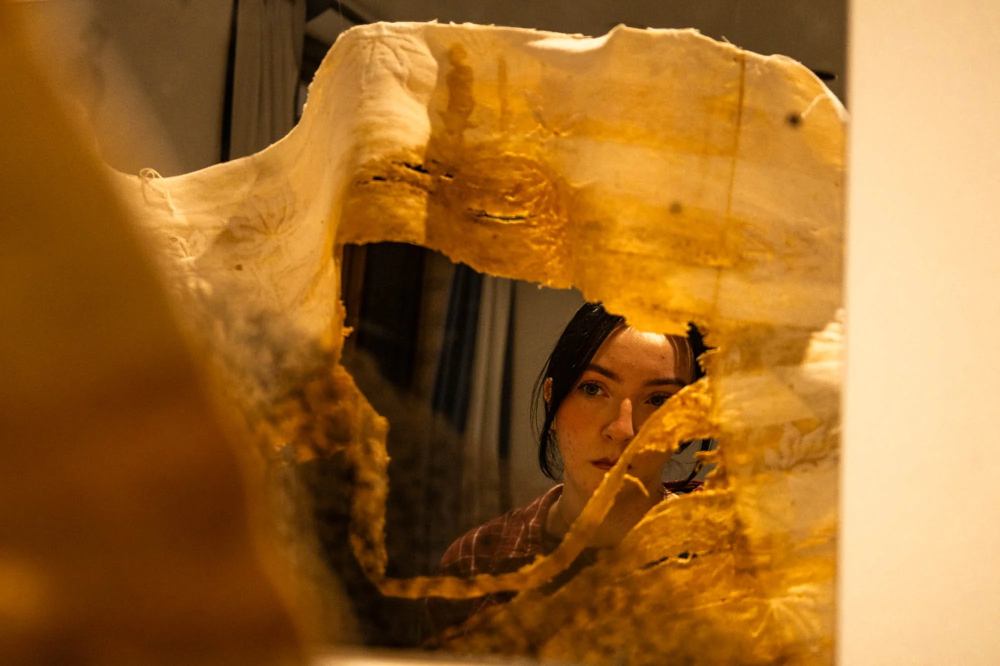 A Moment of Reflection - In the Cora Stafford Gallery, gallery receptionist and UNT senior Lauren Grega views a piece featured in the 65th Paul Voertman Juried Student Exhibition. The piece was created by MFA Sculpture student Nadin Nassar, titled "r