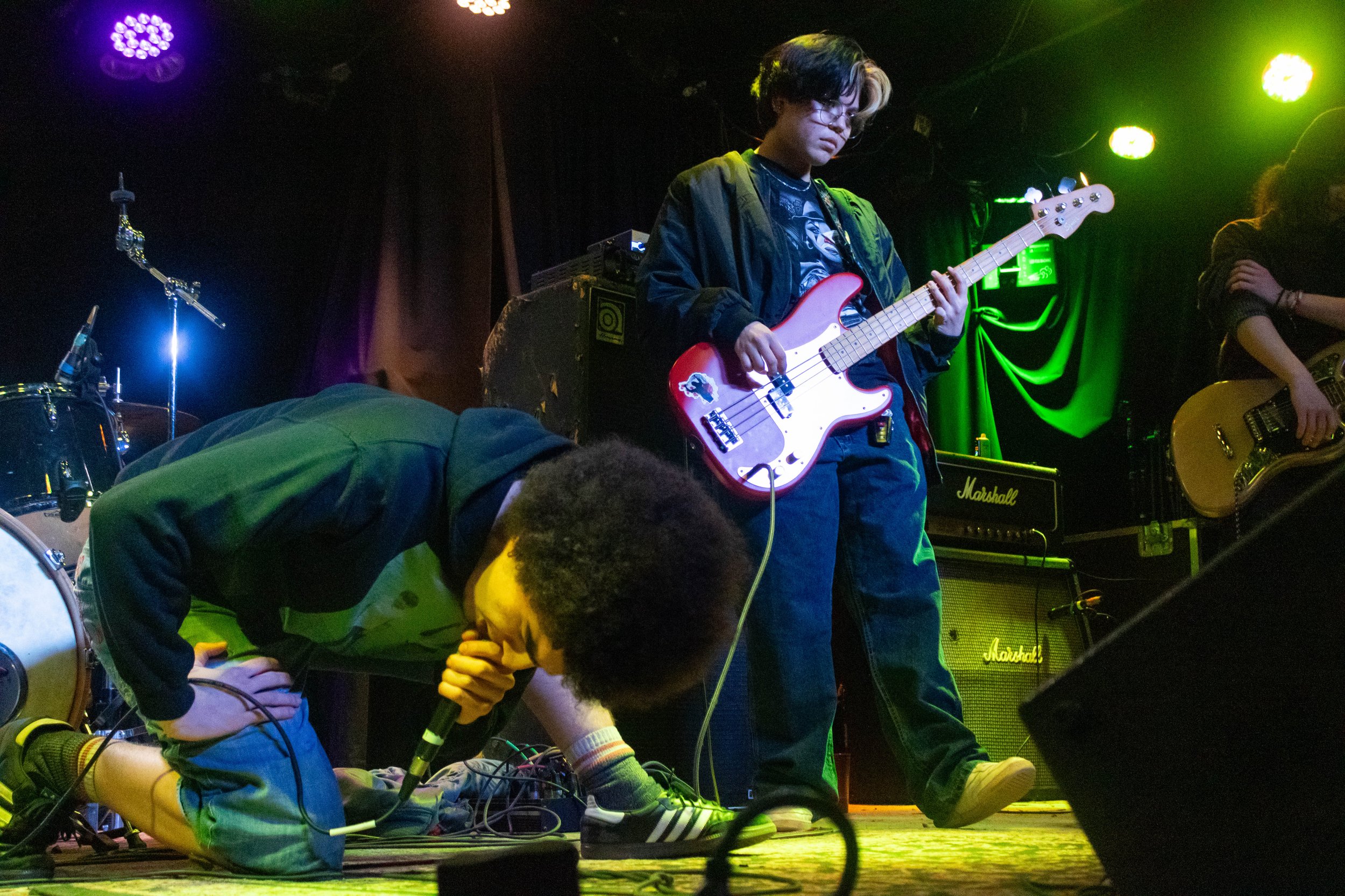Houston sings their song "hindenburg" while Demello plays a baseline behind him.