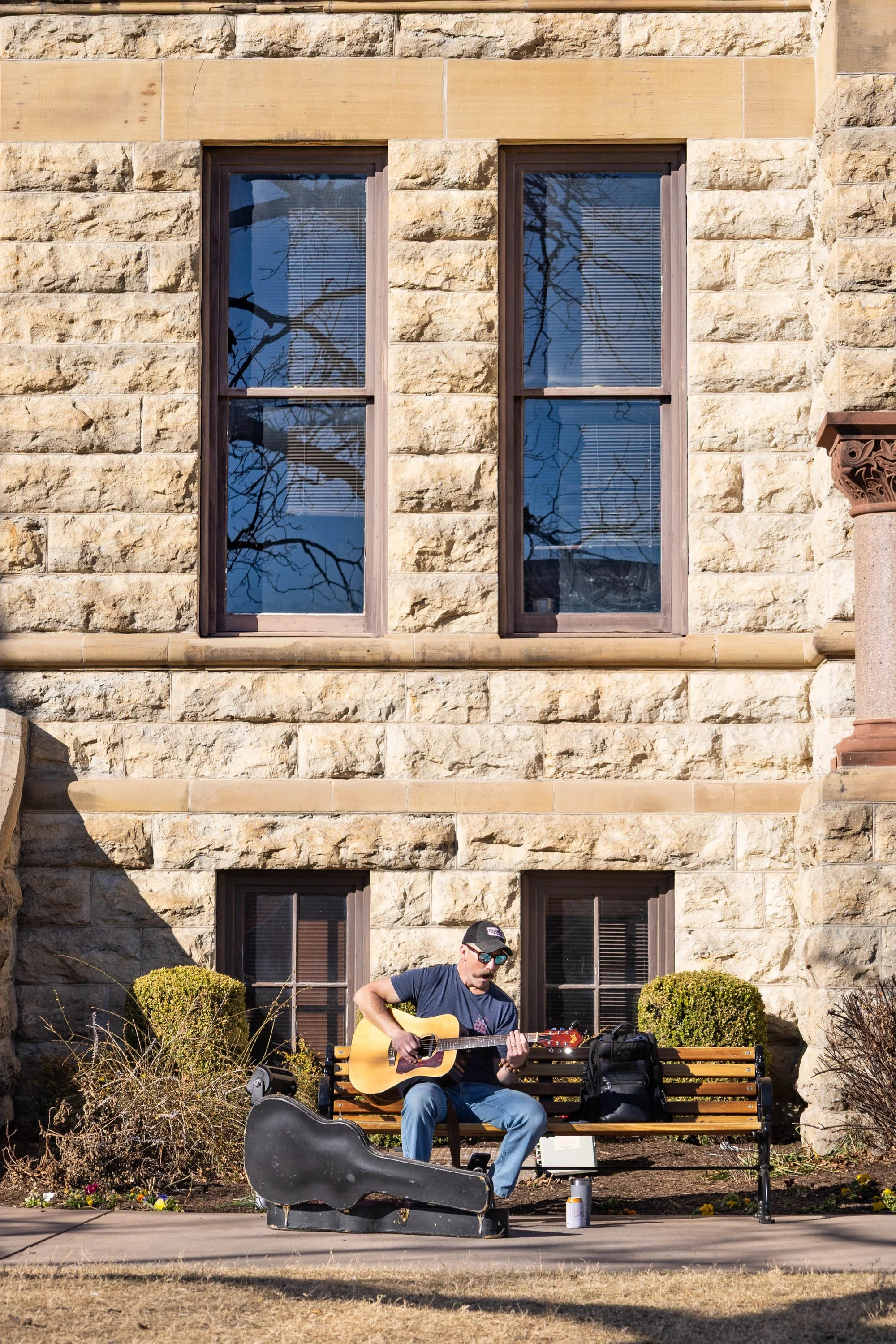 Music in the Sun - In front of the Courthouse on the Square, Denton resident and guitarist Colin Parr plays "Crappy Love Song" by Theo Katzman. Parr plays mostly cover songs. 